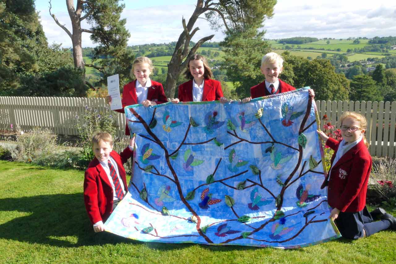 the winning quilt, Free As a Bird, with Belmont Grosvenor School pupils, from left to right, Tom Haggas, Isabelle Fryer, Annabelle Barlow, Jack Shillam and Emily Dennis