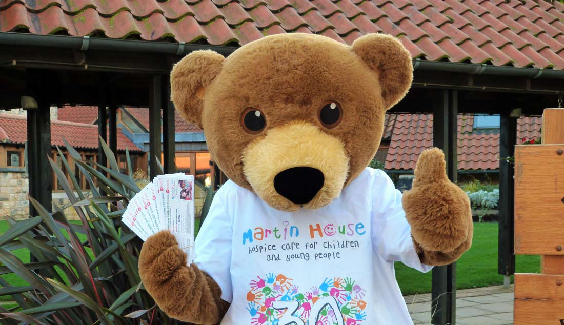 Martin House mascot Marty Bear with the Christmas raffle tickets