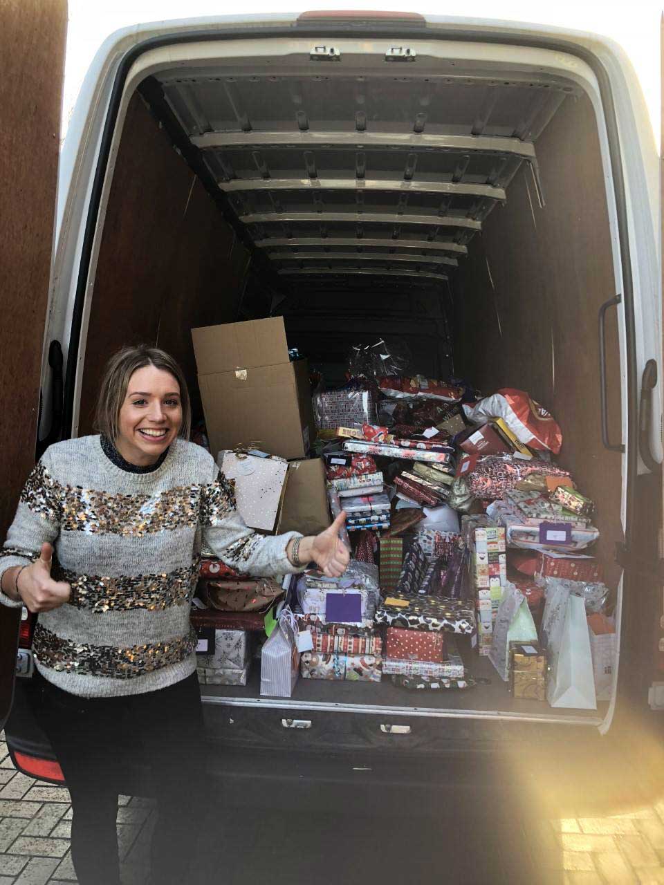 Hettie Flynn with the van full of presents