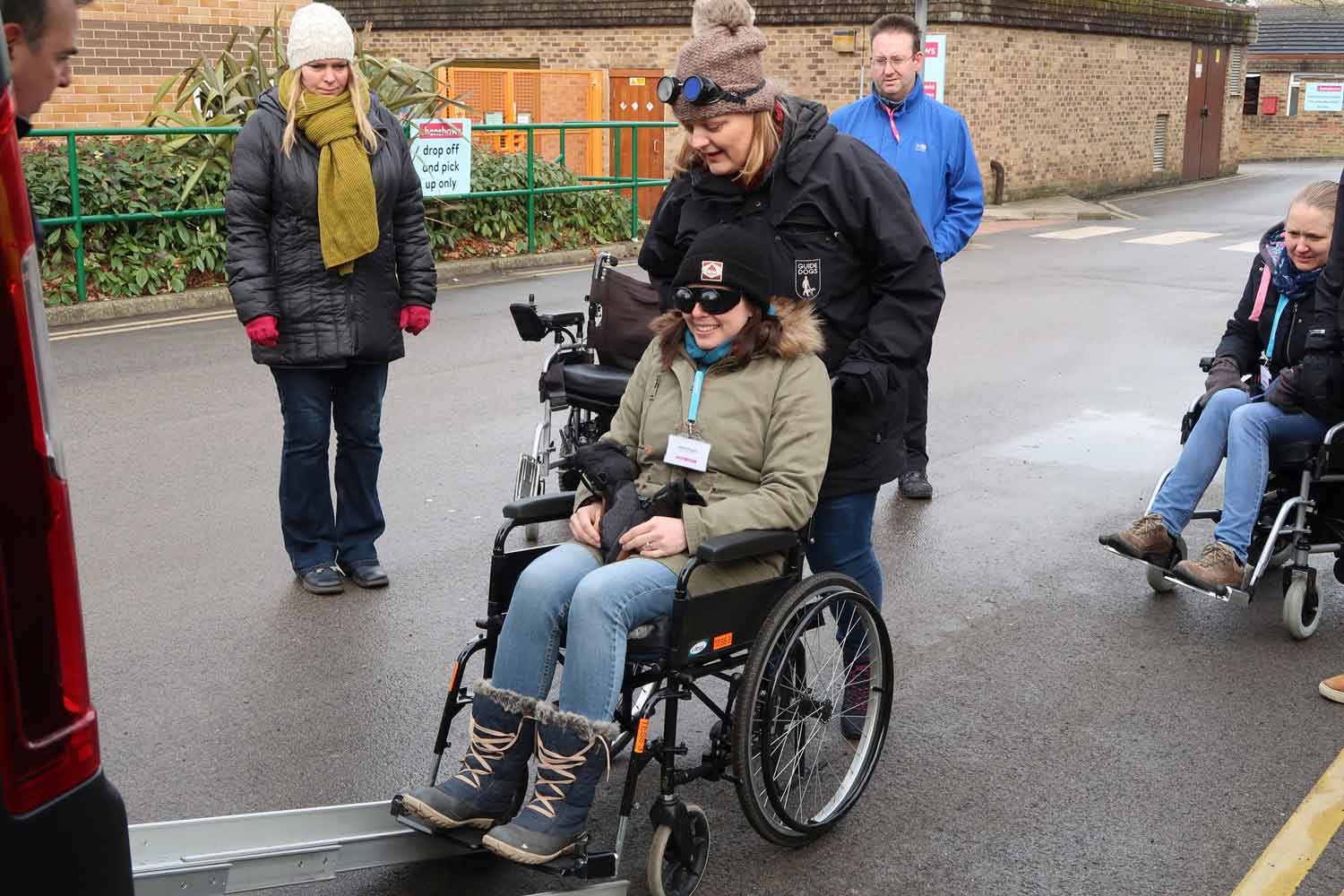 Guide Dogs mobility instructor Lucy Michaliszyn experiences the process of getting a manual wheelchair into a taxi, helped by Janet Kitching, children and young people habilitation specialist