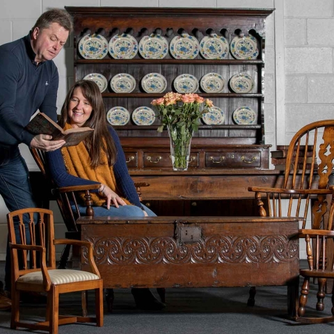 Sam Wigston and Nick Bayliss of Continuity Fairs with furniture including an oak sword chest from the 1600s and Carmarthen oak dresser