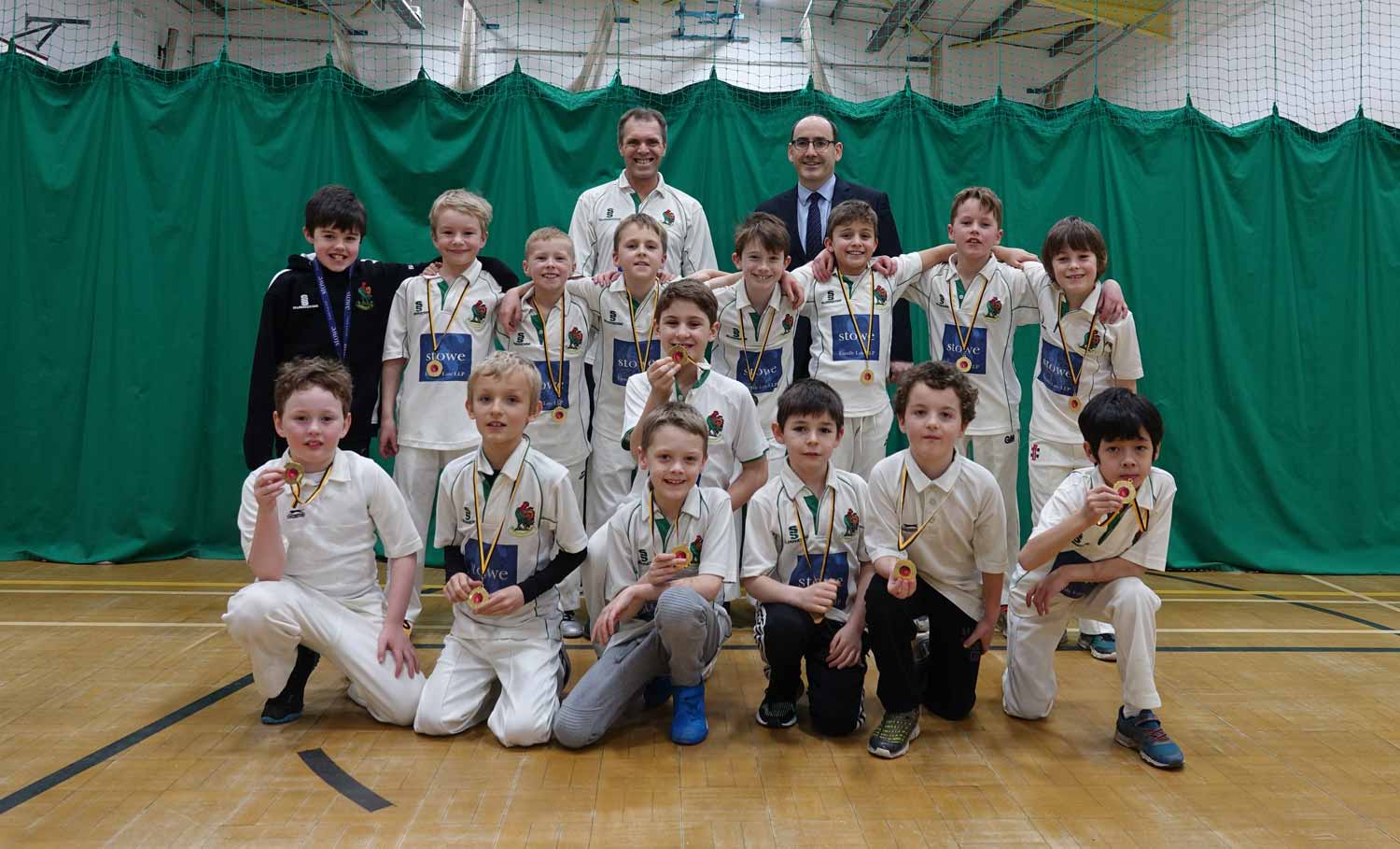 ndoor League Champions! Stowe Family Law CEO Charles Hartwell, back right, and Harrogate U9’s coach Brian Summerson, back left, with the victorious U9’s team sporting their medals