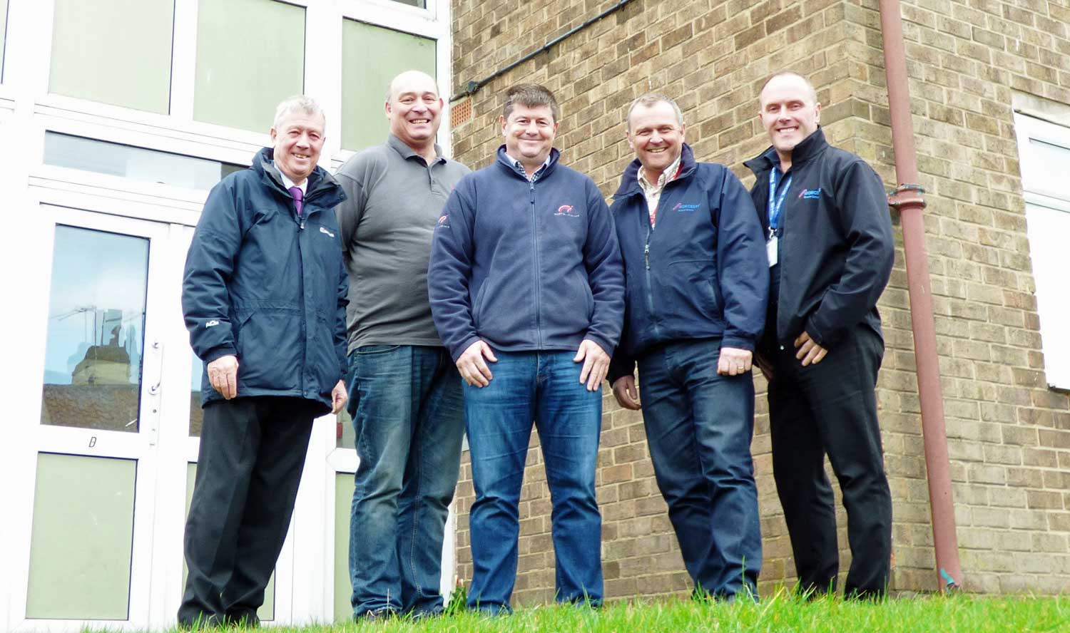 (L-R) Councillor Mike Chambers with maintenance contractors Alistair Symonds (Walter Hartley Ltd), Steven Hepworth (Norton Interiors Ltd), and John Ebbs and Kevin O’Donovan (Help-link UK Ltd), outside the flats on Ripon’s Allhallowgate