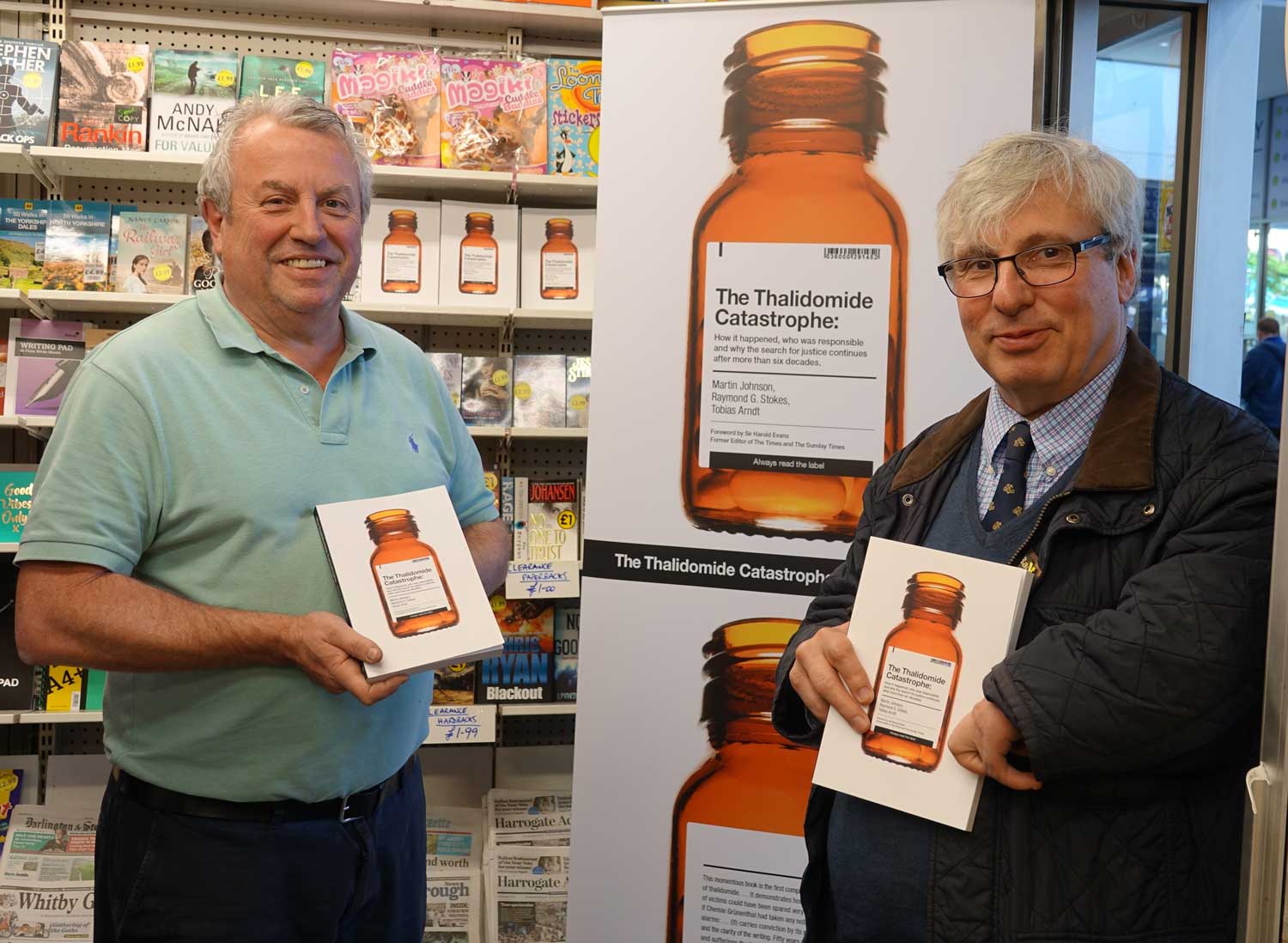Bookstall owner, Brian Moses, left, with thalidomide campaigner Guy Tweedy and copies of the new book - The Thalidomide Catastrophe