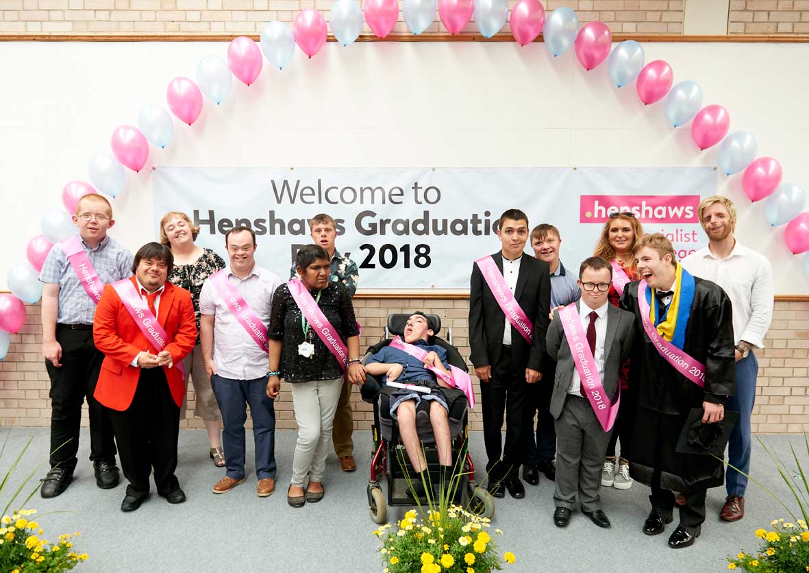 The class of 2018 celebrating their graduation with, far right, speaker Jono Lancaster