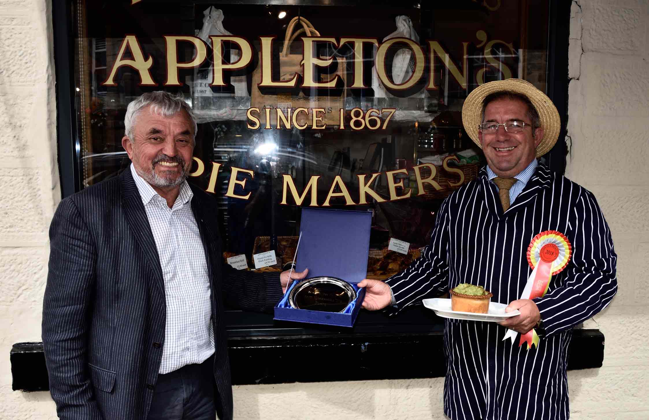 Award-winning pie maker Kevin Wilson of Appleton's Butchers receives his trophy and rosette from Tockwith Show vice-chairman Allan Robinison