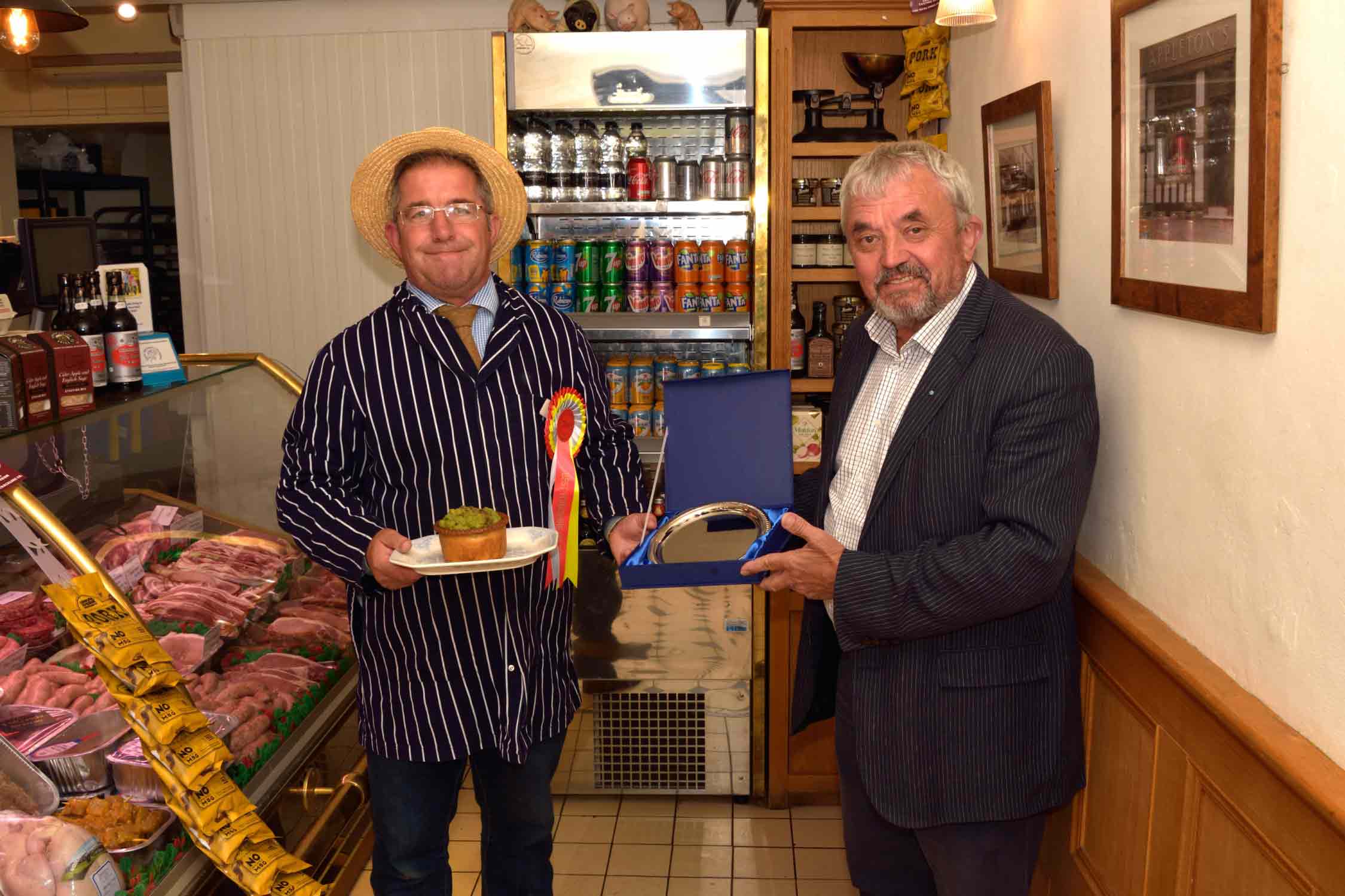 Award-winning pie maker Kevin Wilson of Appleton's Butchers receives his trophy and rosette from Tockwith Show vice-chairman Allan Robinison