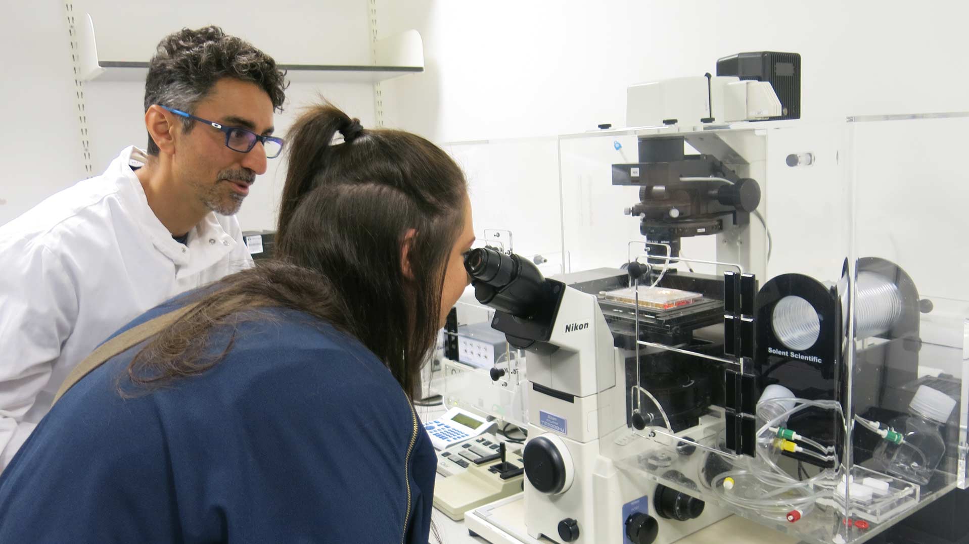 Melissa Foulis looking through microscope at the Centre of Excellence