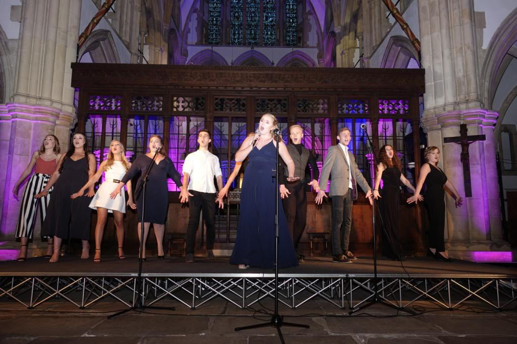 Raising Funds And Raising the Roof! Niamh Boyle, front and centre, sings the opening number at the “Songs from the Musicals” concert held in St Wilfrid’s Church