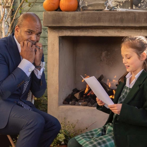 errifying-tale-Tilly-Reid-reading-her-winning-ghost-story-to-Rodney-Prosper-general-manager-of-The-Ivy-Harrogate