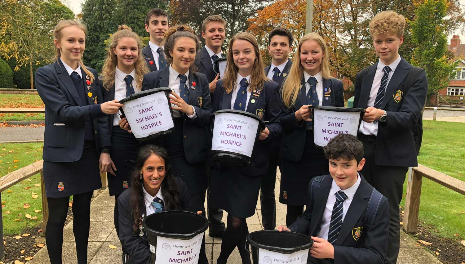 Grace and Louise (pictured centre L and R ) surrounded by some of this students raising money for the hospice