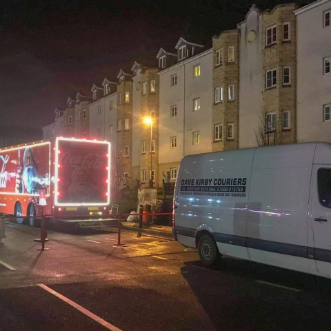 Christmas has come early! The Coca-Cola Christmas Truck next to a Dave Kirby Courier’s van