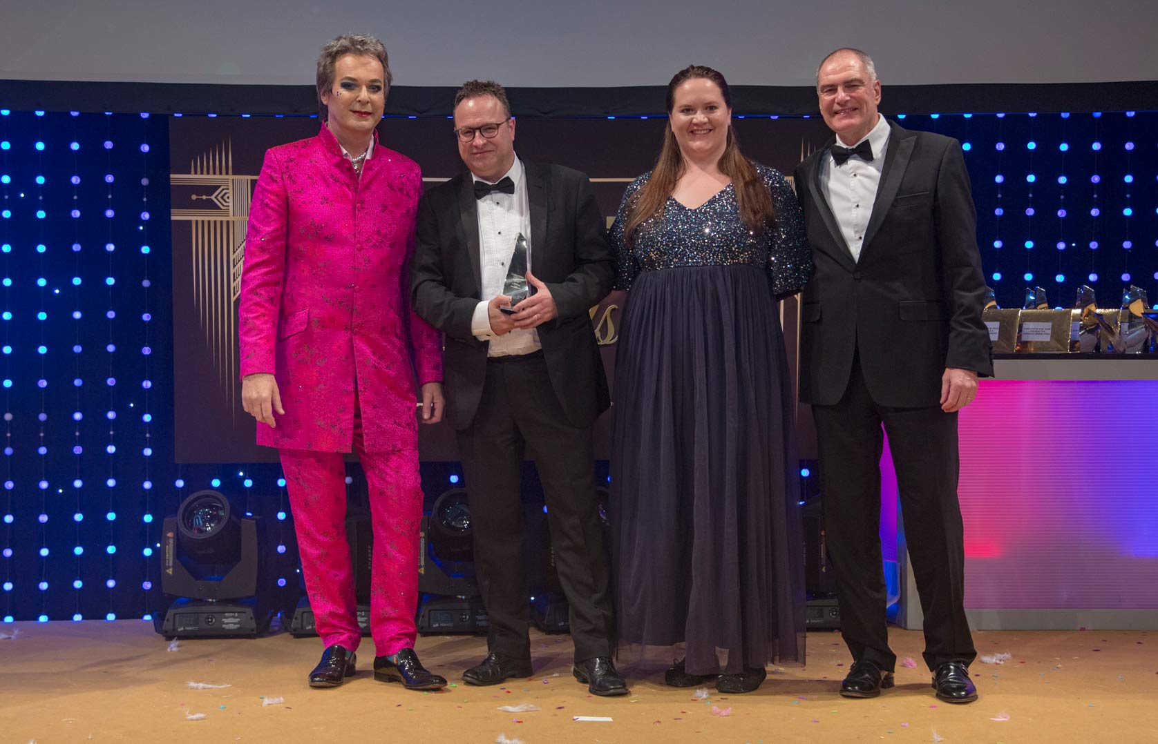 David Waddington, Land and New Homes Director at Linley & Simpson, picks up the Community Champion gold award on behalf of the agency from comic Julian Clary and sponsors