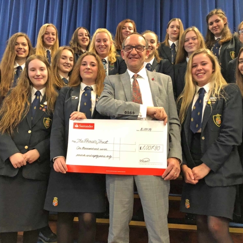 Natasha and her team present a cheque for more than £1,000 to Bjorn Risi