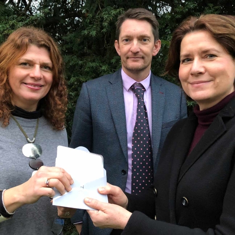 Alison Robinson, right, pictured with headmaster Jonathan Webb and head of art Fiona Henson, with her invites to Champagne afternoon tea at Bettys