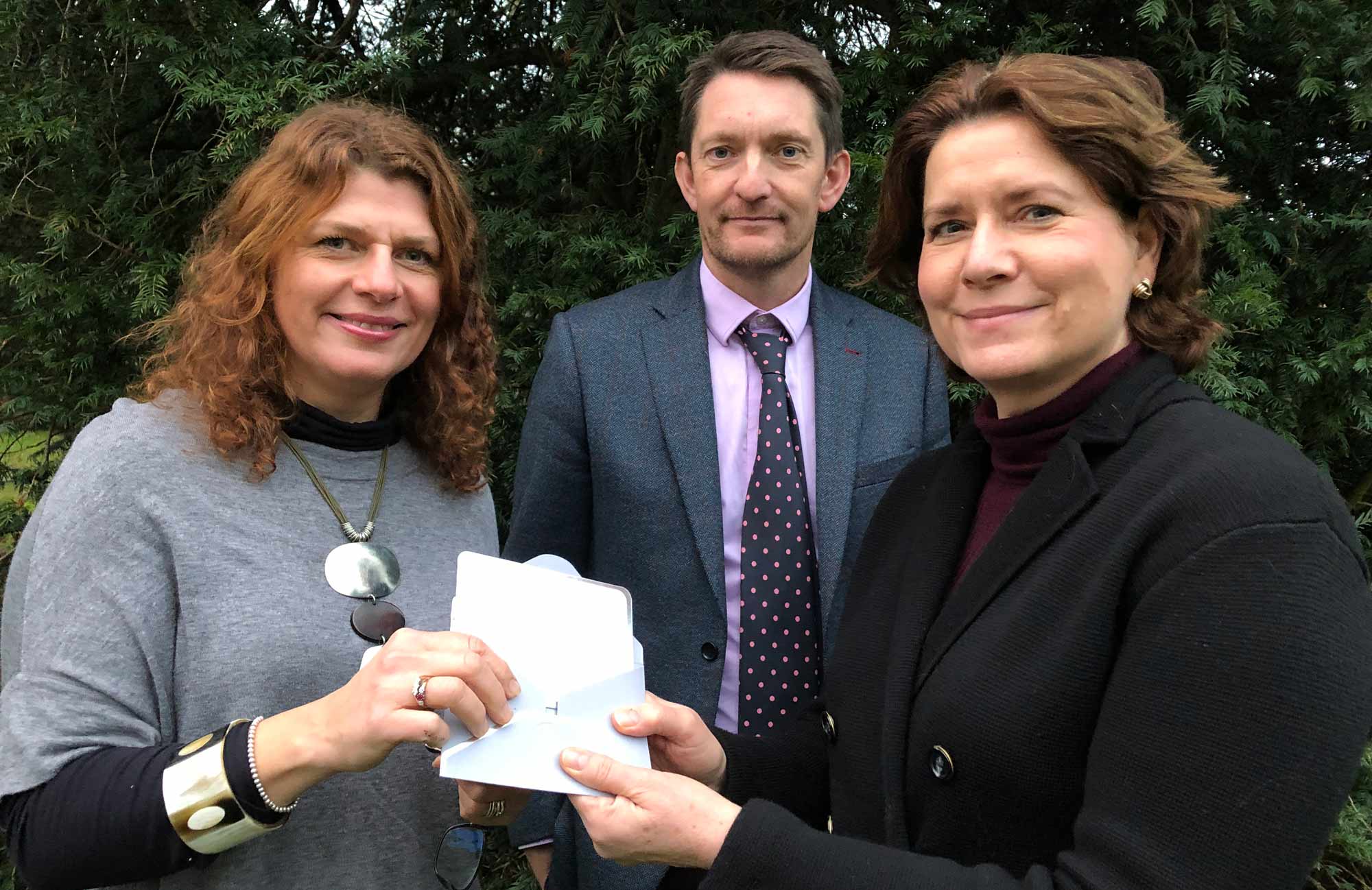 Alison Robinson, right, pictured with headmaster Jonathan Webb and head of art Fiona Henson, with her invites to Champagne afternoon tea at Bettys