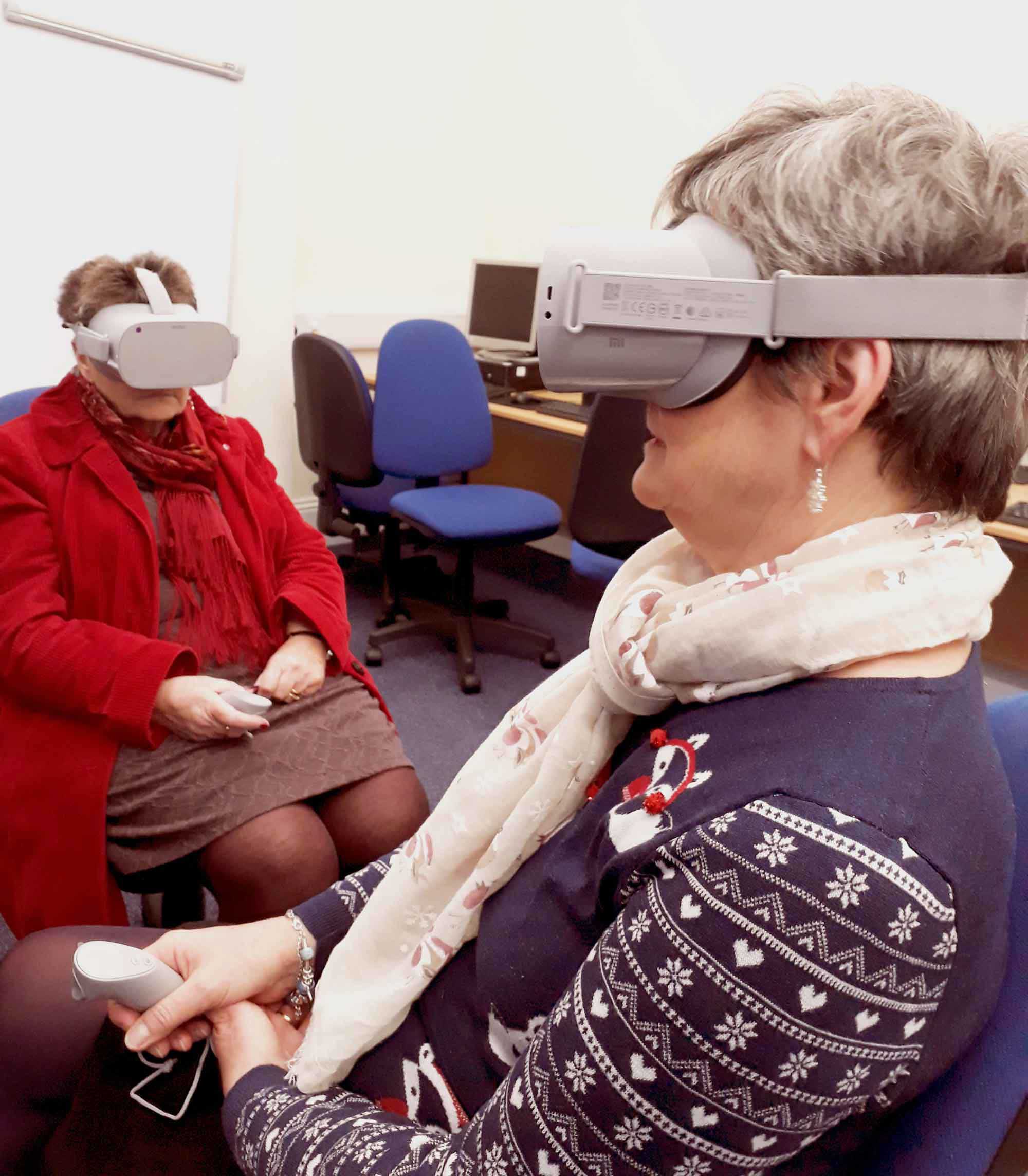 Two users at Harrogate Library try out the Virtual Reality headsets
