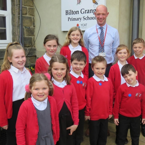 Deputy headteacher Richard Street with pupils from years 2 to 6 at Bilton Grange Primary School