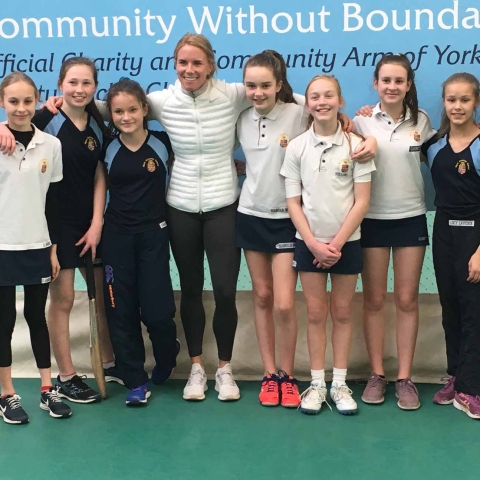 the cricket team pictured with Lauren Winfield, centre, and Yorkshire County Cricket Club girls' community coach Rachel Hildreth, right