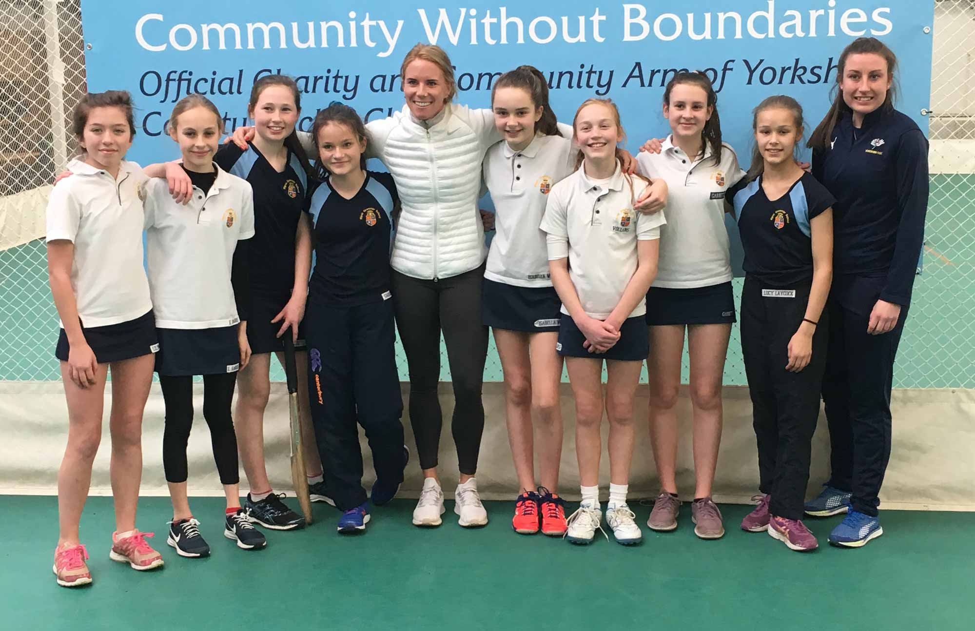 the cricket team pictured with Lauren Winfield, centre, and Yorkshire County Cricket Club girls' community coach Rachel Hildreth, right