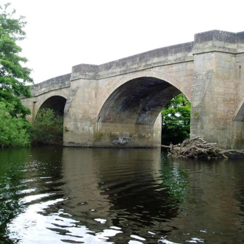 Grade II listed Masham Bridge spanning the River Ure.