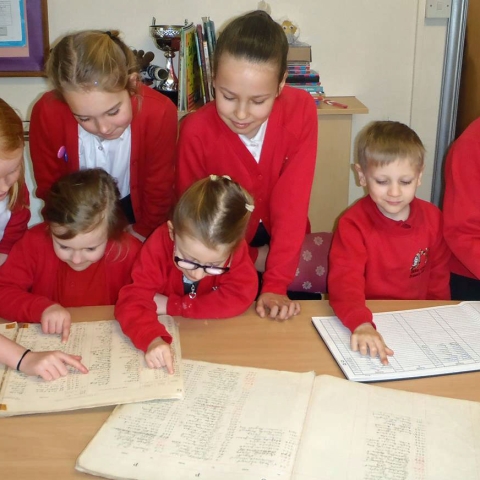Pupils from Bilton Grange Primary School look at the original log books from 1919 as they prepare to celebrate the school’s centenary
