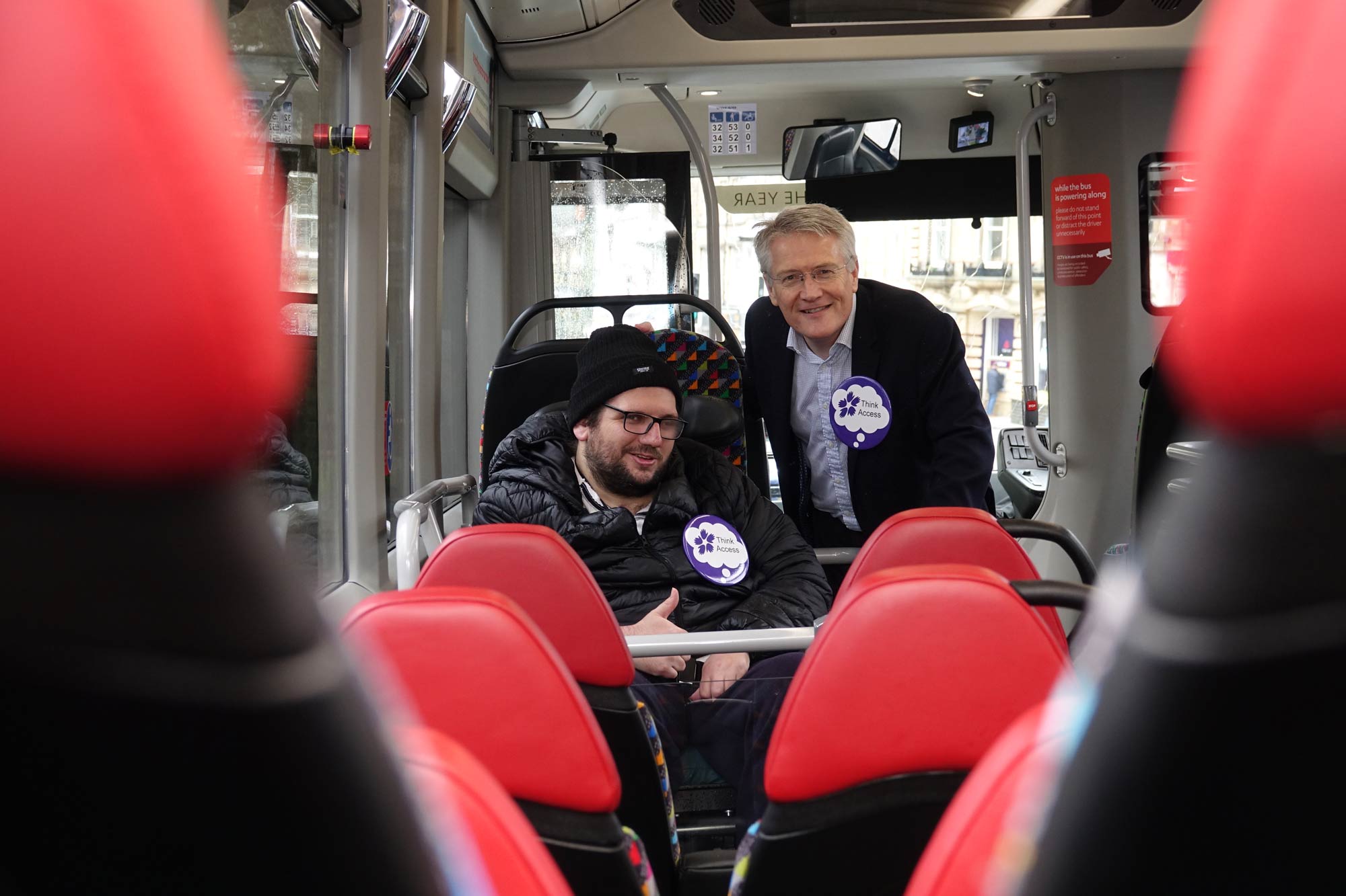 Disability Action Yorkshire customer Darren Asquith and MP Andrew Jones on board the new electric Transdev bus