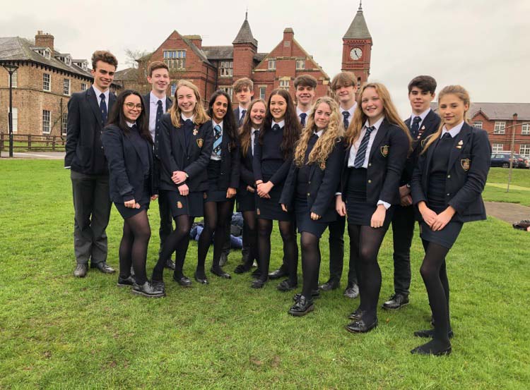 Some of last year’s high-achieving GCSE students outside the school