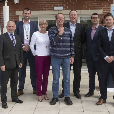Tim (centre, wearing the tracker) with Cllr Michael Harrison (far left) and David Straughan, NRS, Managing Director National Care; Rebecca Dukes, North Yorkshire County Council, Housing Market Development Team; Nigel Thacker, NRS Development Director; James Lampert, NRS Head of Technology Enabled Care Services; Danny Shepherd, NRS Assistive Technology Manager