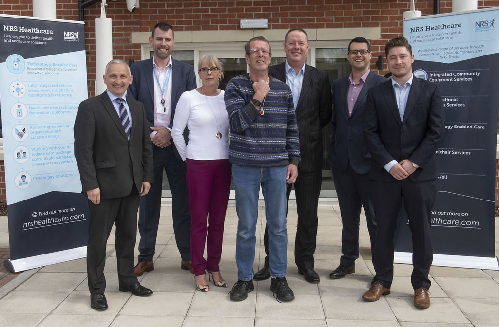 Tim (centre, wearing the tracker) with Cllr Michael Harrison (far left) and David Straughan, NRS, Managing Director National Care; Rebecca Dukes, North Yorkshire County Council, Housing Market Development Team; Nigel Thacker, NRS Development Director; James Lampert, NRS Head of Technology Enabled Care Services; Danny Shepherd, NRS Assistive Technology Manager