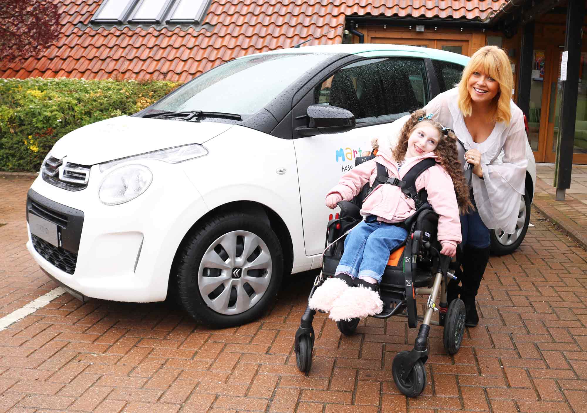 Christine Talbot launches the Martin House Grand Car Raffle with the help of Lacie-Lea Rennie