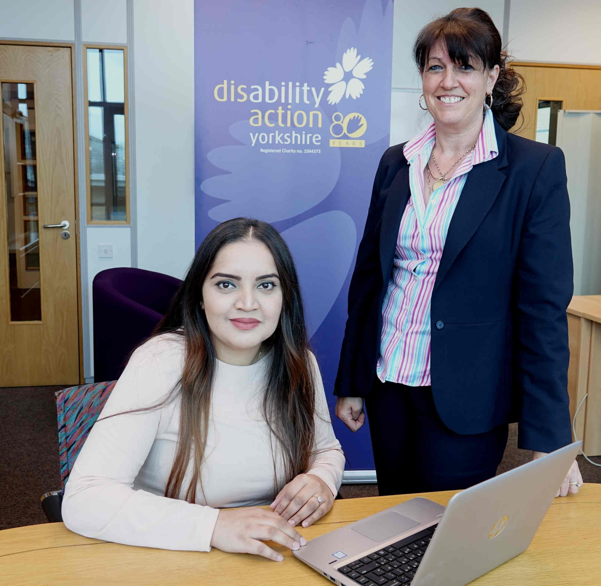 Disability Action Yorkshire entrepreneur coach Iram Khan, seated, with Denise Baynton, Disability Action Yorkshire’s training operations manager