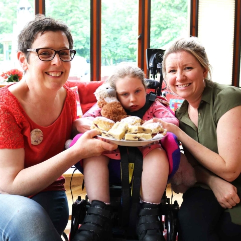 Martin House artist in residence Helen Scouller with Olivia Evans, nine, and her mum Hannah Evans preparing for the Big Bake
