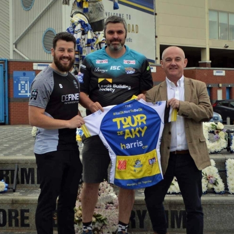 (left to right) Antony Woods of Defined Intervention, the supplier of the cycling jerseys, PC Pierre Olesqui who organised the event and Paul Taylor of sponsors Harris CM, outside Elland Road which is one of the locations the ride will visit