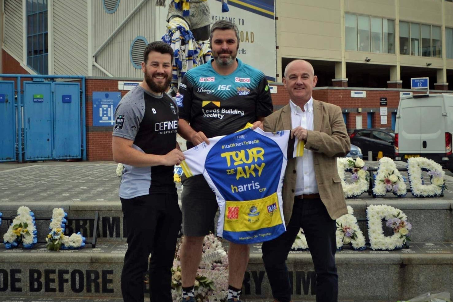 (left to right) Antony Woods of Defined Intervention, the supplier of the cycling jerseys, PC Pierre Olesqui who organised the event and Paul Taylor of sponsors Harris CM, outside Elland Road which is one of the locations the ride will visit