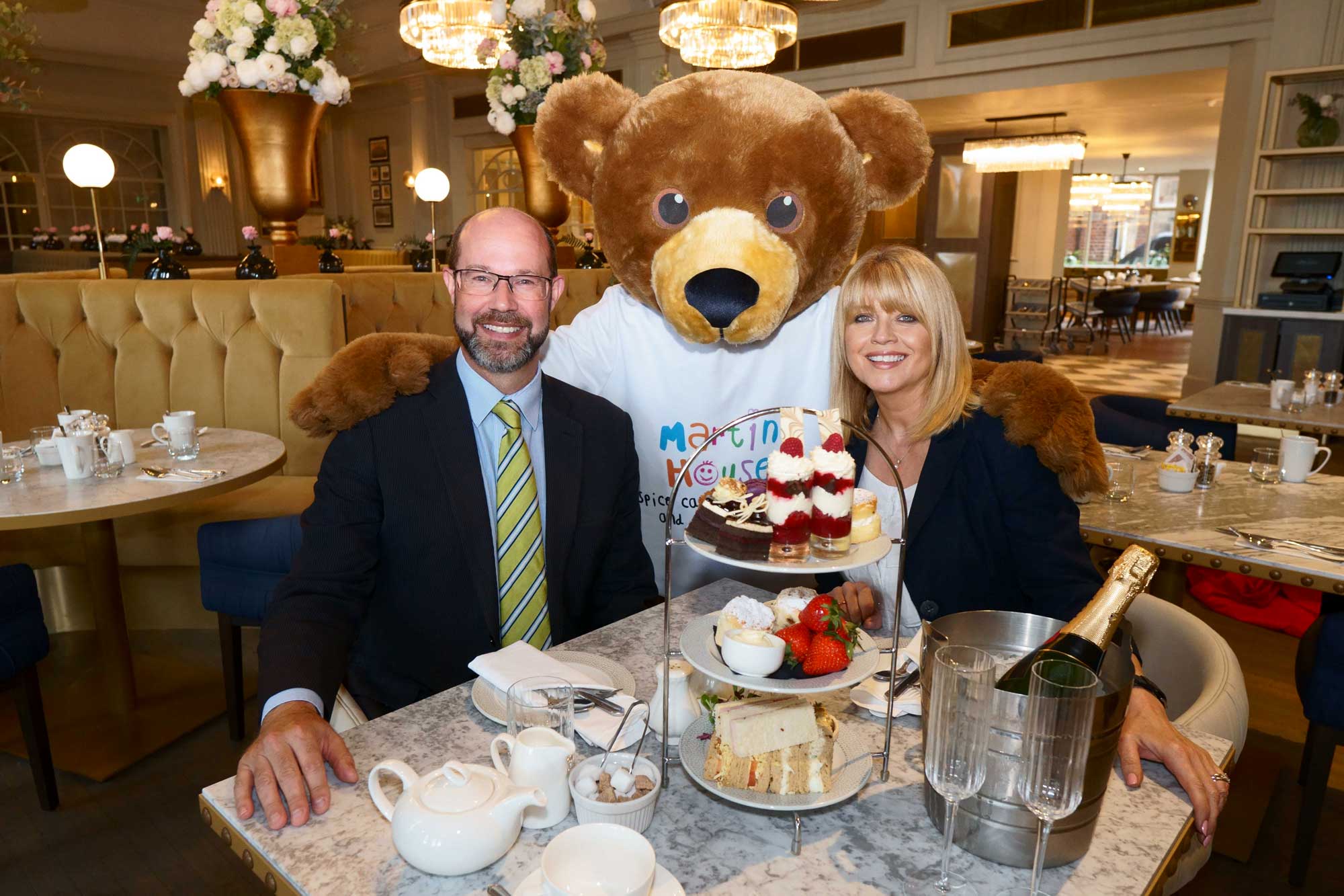 Tea Up! Martin House Children’s Hospice ambassador, Christine Talbot, is joined for afternoon tea at the Majestic Hotel by general manager, Matthew Hole, and Martin House mascot, Marty Bear
