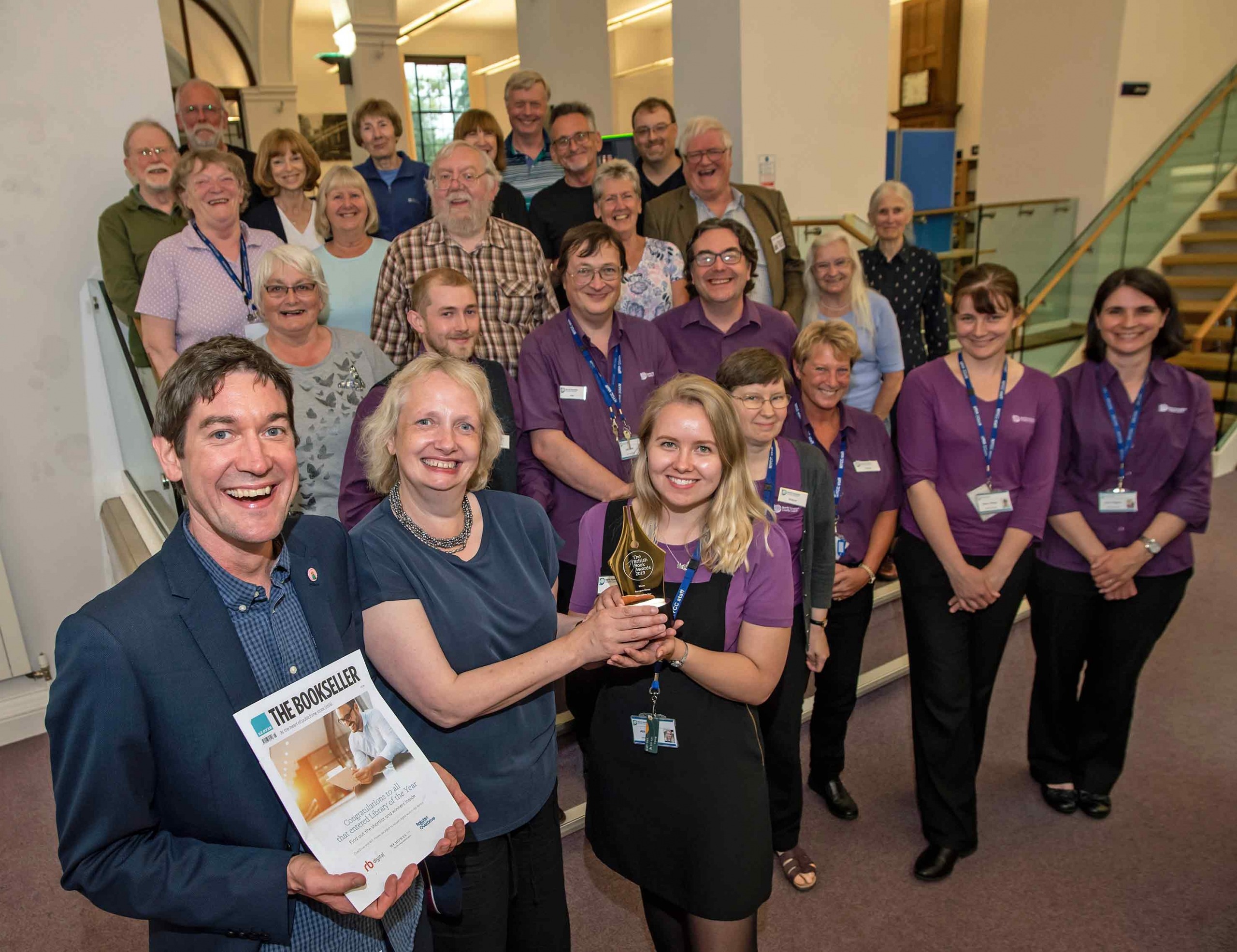 Benedicte Page presents the award to library supervisor Abigail Tanner with (left) Fraser Hutchinson of the Reading Agency, staff and volunteers from Harrogate library and local authors