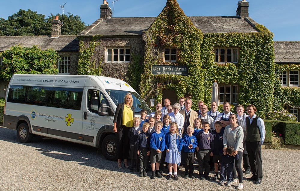 On track for success: Lynette Brammah (far left) with Frances Atkins and Jonathan Turner (centre) with) and pupils from The Federation of Fountains Earth and St Cuthbert's C of E Primary Schools