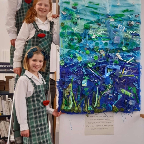 sisters Beatrice, Eliza and Theadora Haddow with their art in Harrogate library