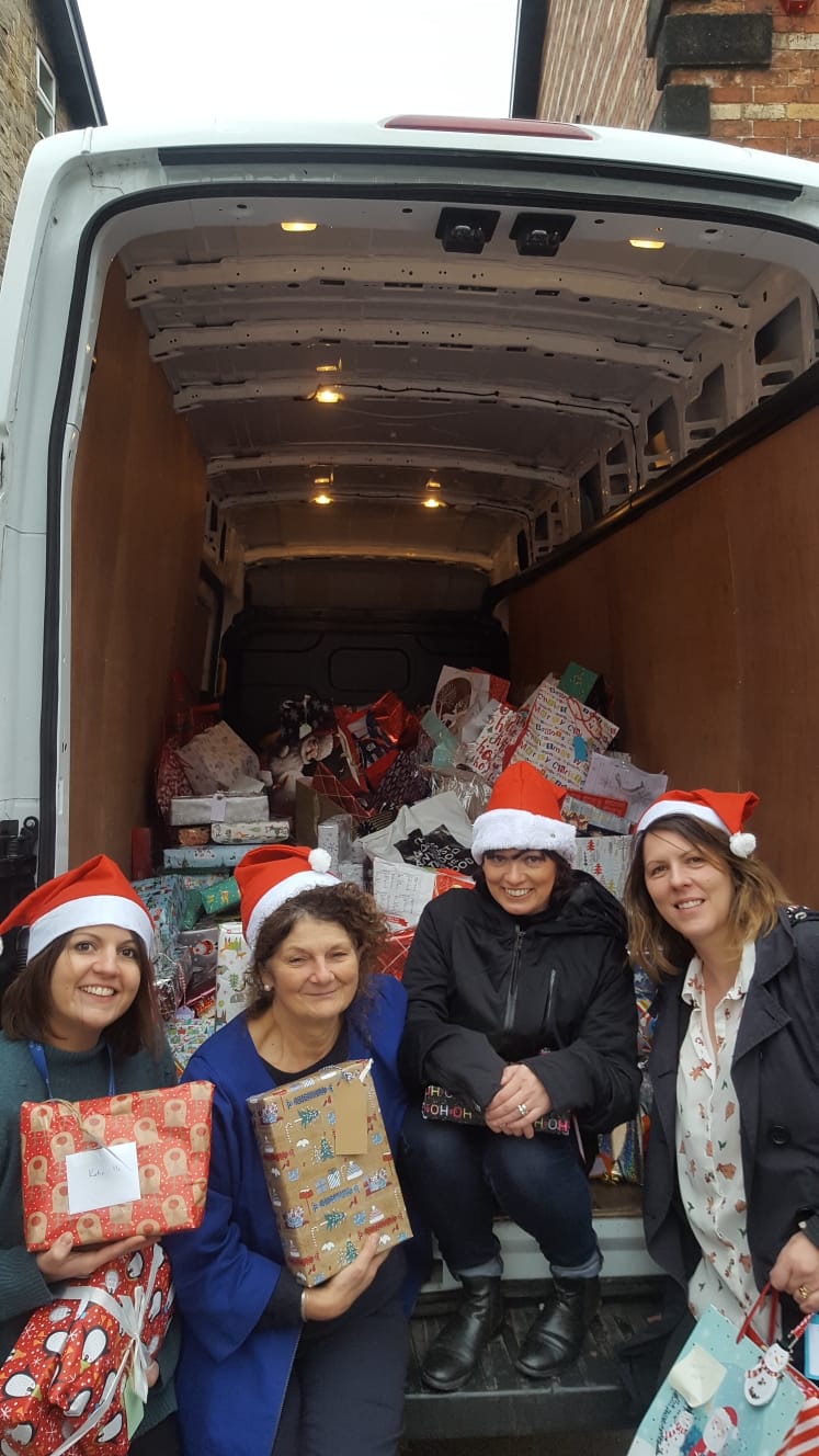 l-r Sarah Beard (quoted), Alison Straw, Grainne McGinty-Foster and Helen Prince with the van of presents