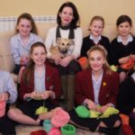 Headmistress Mrs Sophia Ashworth Jones, school dog Zola and Belmont Grosvenor School pupils