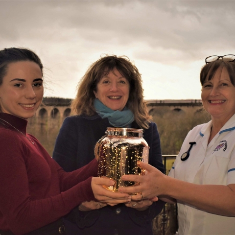 Saint Michael’s team members, holding the limited edition keepsake lantern, in the grounds of Saint Michael’s Hospice, Harrogate