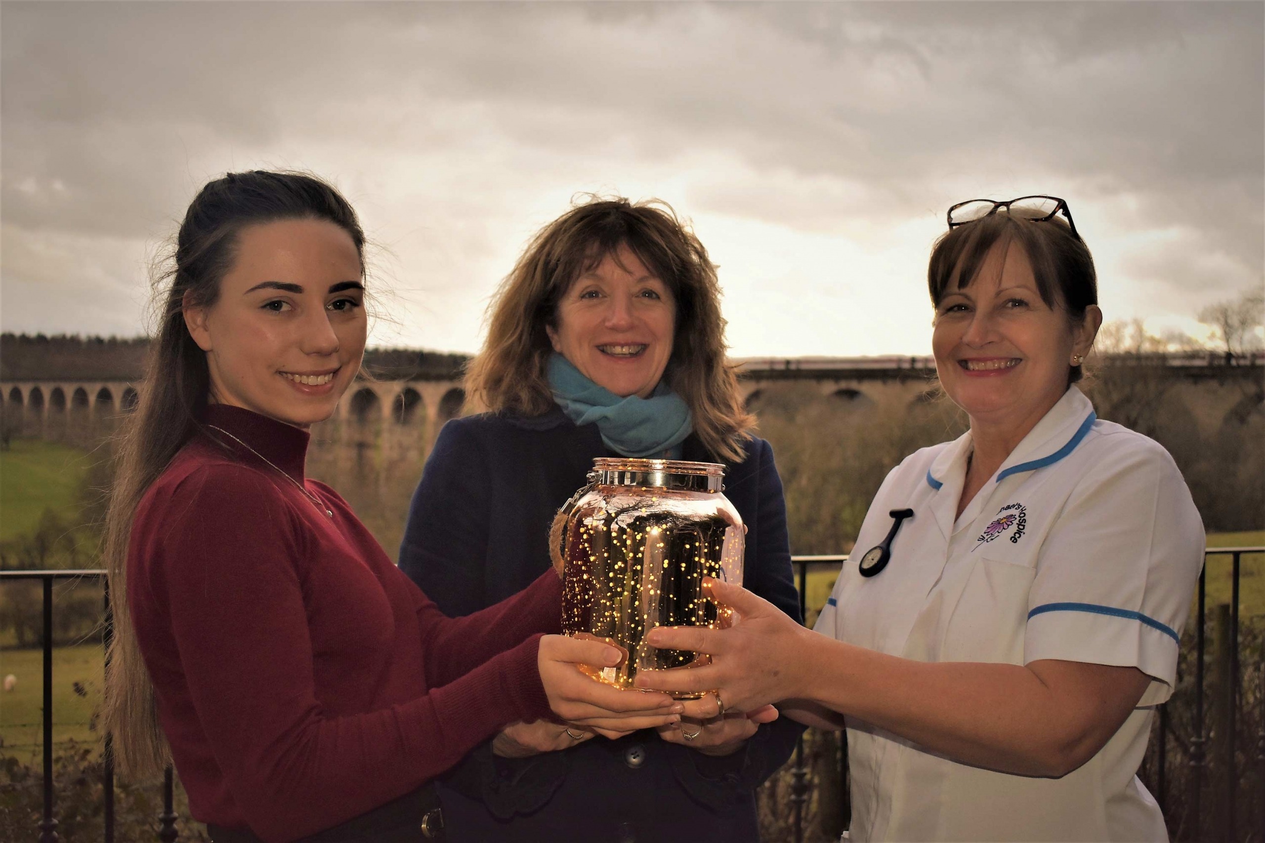 Saint Michael’s team members, holding the limited edition keepsake lantern, in the grounds of Saint Michael’s Hospice, Harrogate