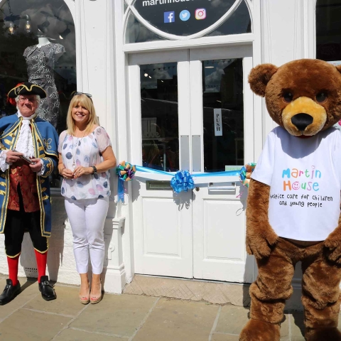 ITV Calendar presenter Christine Talbot, and Knaresborough Town Crier Roger Hewitt open the Martin House Knaresborough shop last July, with the help of Marty Bear