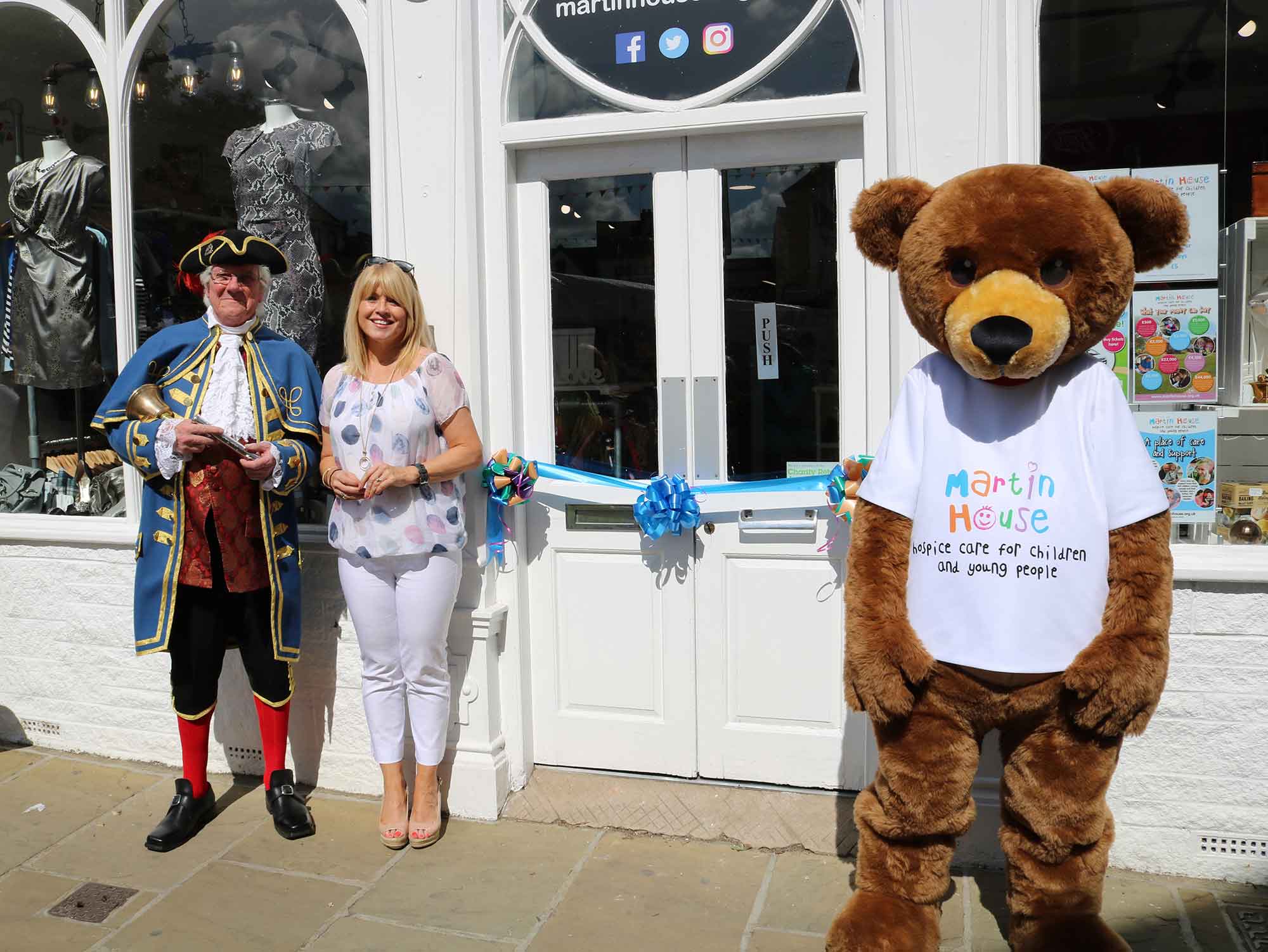 ITV Calendar presenter Christine Talbot, and Knaresborough Town Crier Roger Hewitt open the Martin House Knaresborough shop last July, with the help of Marty Bear