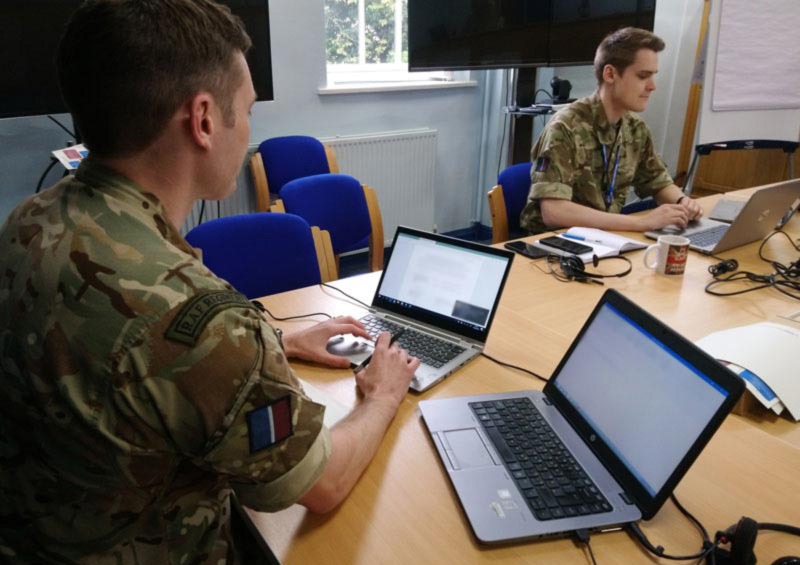 Flying Officer Sam Watson and Flight Lieutenant Graham Ivison working during the pandemic