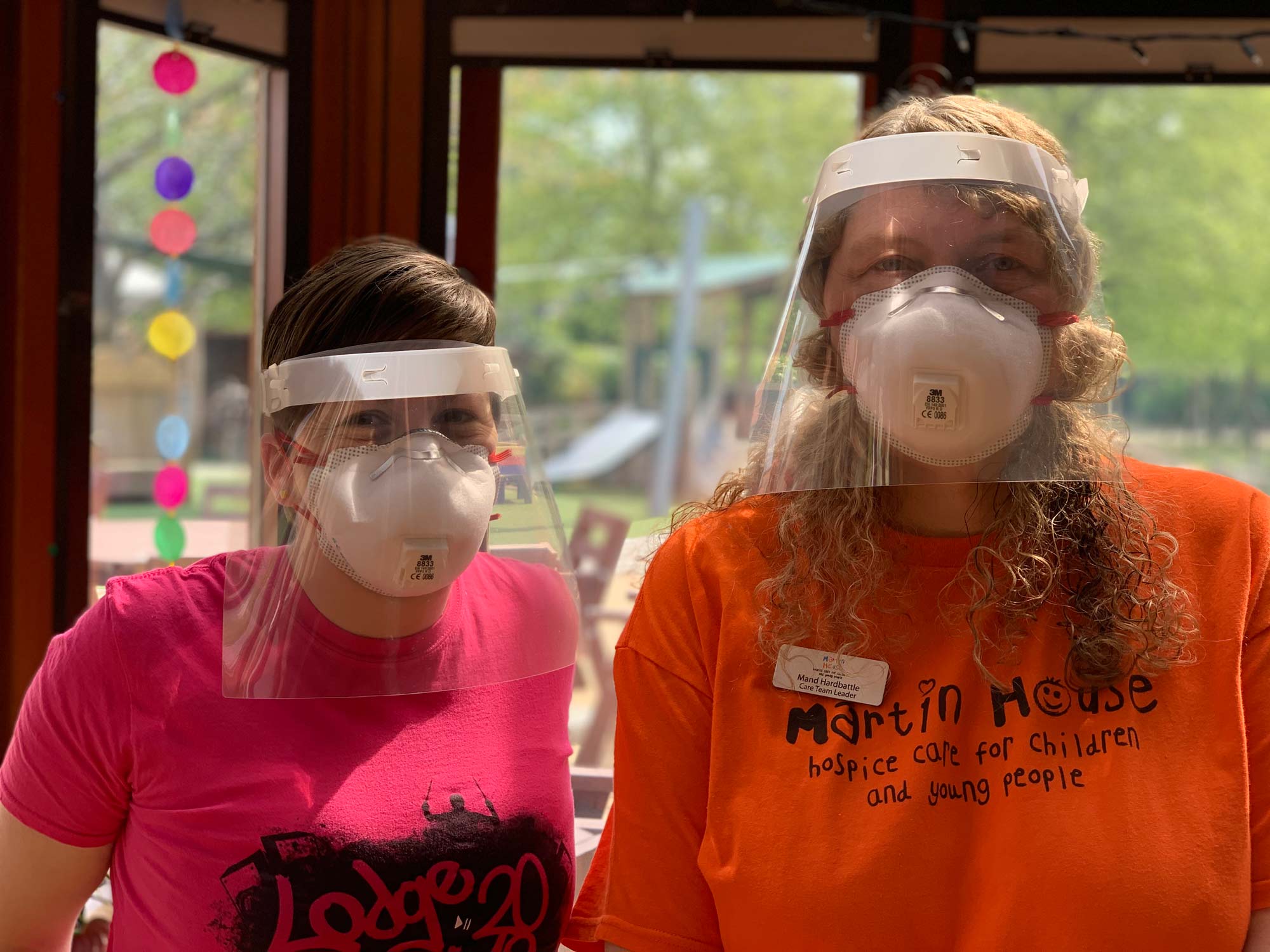 Two of Martin House’s care team in some of the PPE they will wear while caring for children.