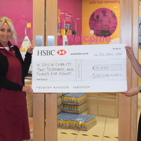 NHS Nurses June Watts on the left and Annabelle Feetenby on the right receiving the Soccersixes Cheque for £2025