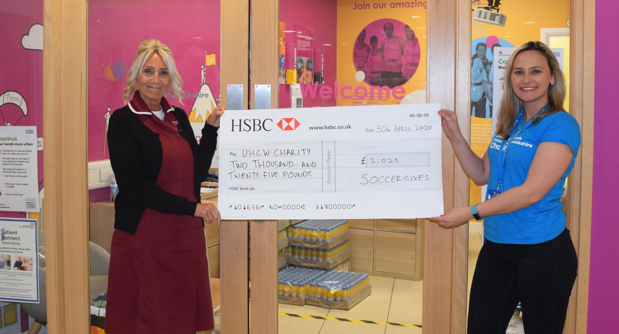 NHS Nurses June Watts on the left and Annabelle Feetenby on the right receiving the Soccersixes Cheque for £2025