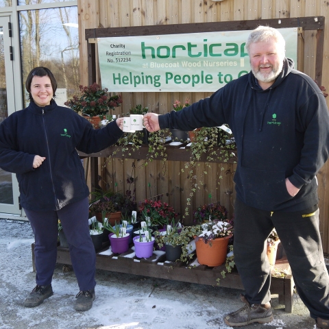 Phil Airey, Operations Manager at Horticap, and student Rebecca raising their mugs to Belmont Grosvenor School to say thanks for the cash boost